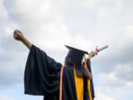 long-haired-female-students-wearing-black-ruffle-dresses-expressing-joy-graduation-university_43157-719